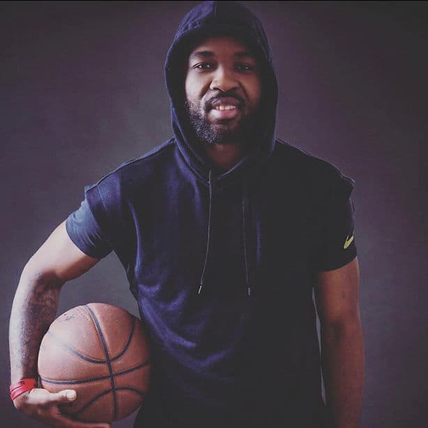 Coach training young basketball players